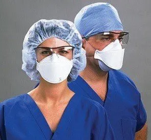 Dental staff wearing masks, googles, and hairnets